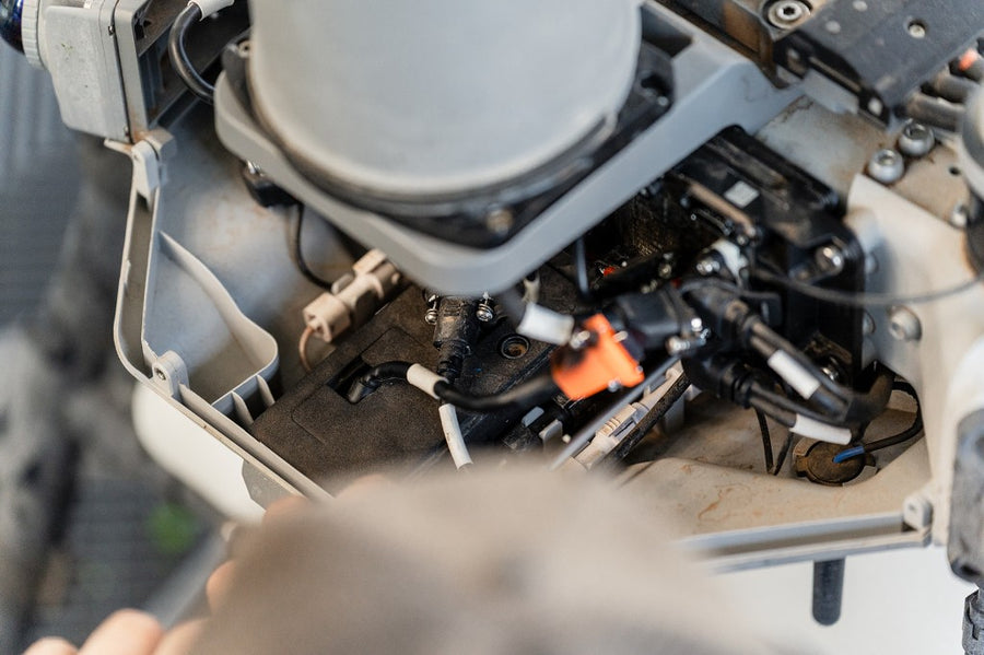Workshop service on an Agras — opening the airframe to check the job.