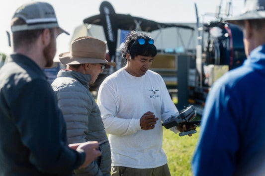 Technician walking a farmer through the Agras controller